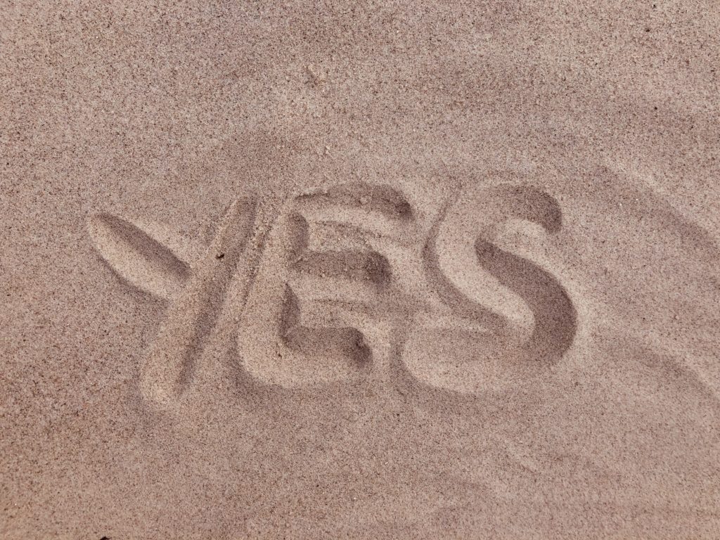 Palabra Yes escrita en la arena